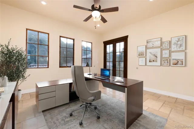 a view of a workspace with furniture and a chandelier