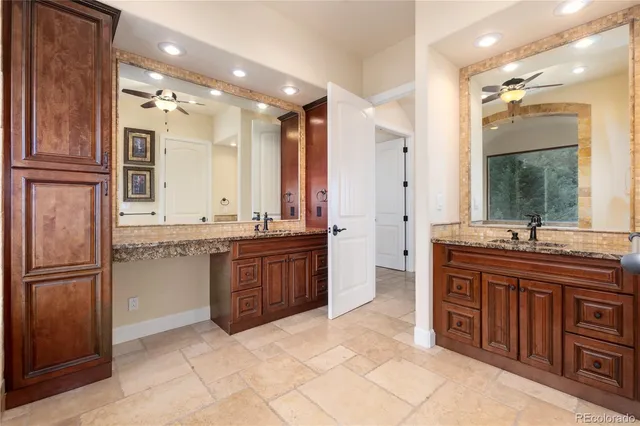 a bathroom with a granite countertop sink mirror and a bathtub