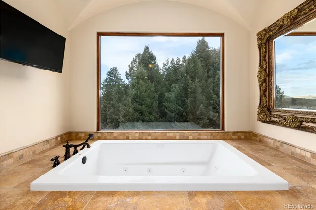 a bath tub sitting in a bathroom next to a window