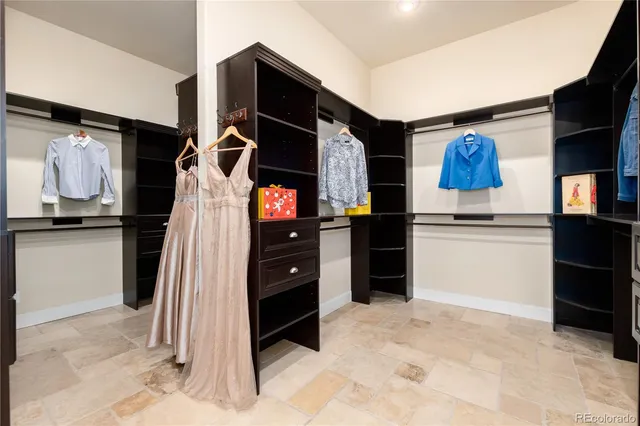 a kitchen with stainless steel appliances kitchen island granite countertop a refrigerator and a sink