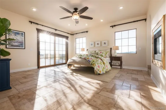 a spacious bedroom with a bed mirror and window
