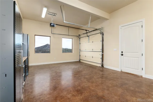 an empty room with windows and cabinet