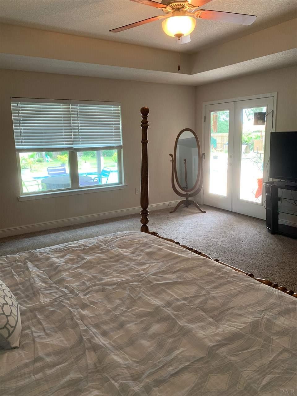 4061 Millwright Way Pace, FL 32571 - Photo 13 of 46 Trey ceiling and patio door to pool area