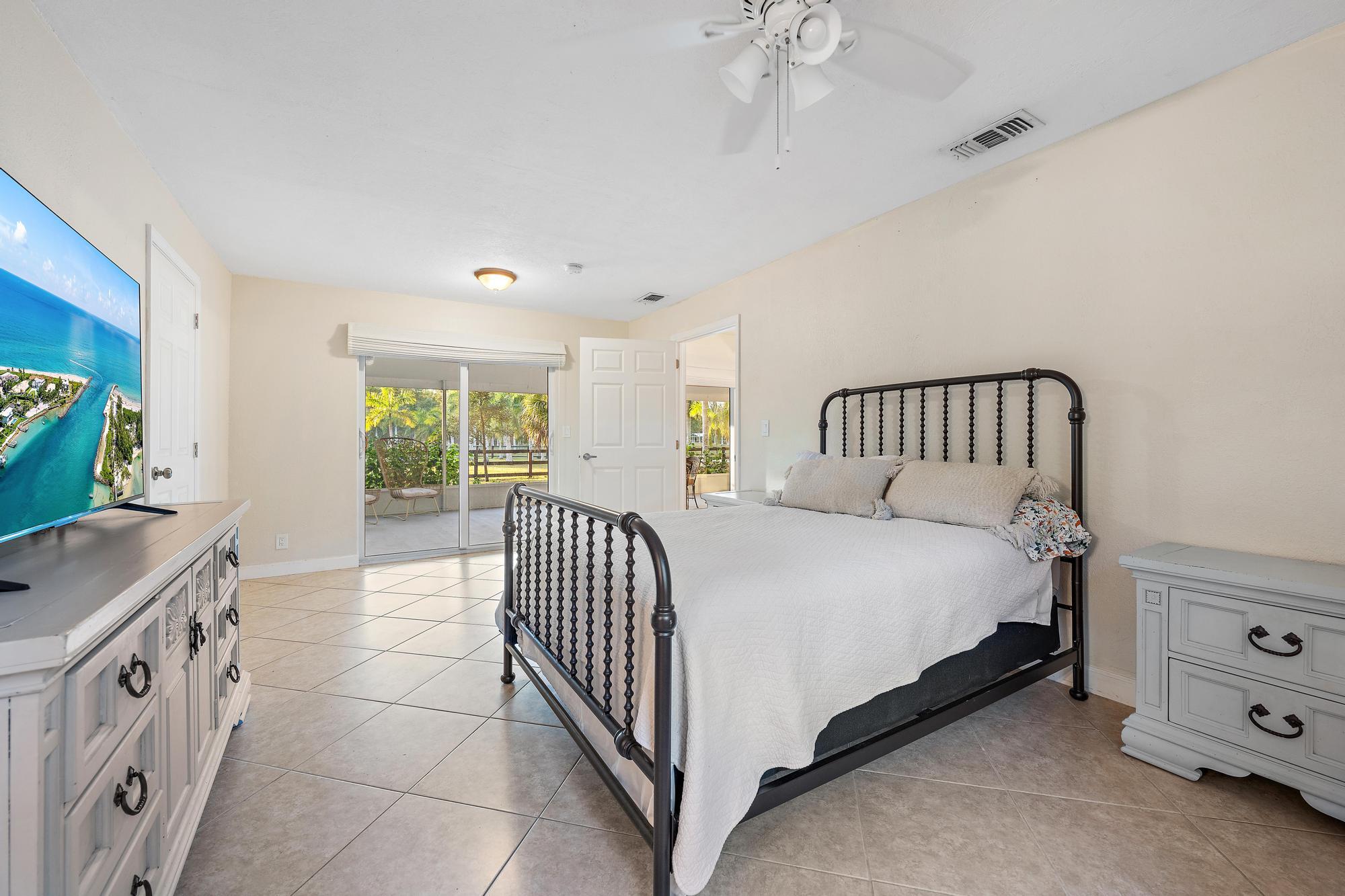 14765 Calusa Trail Palm Beach Gardens, FL 33418 - Photo 18 of 49 a bedroom with a bed and a window