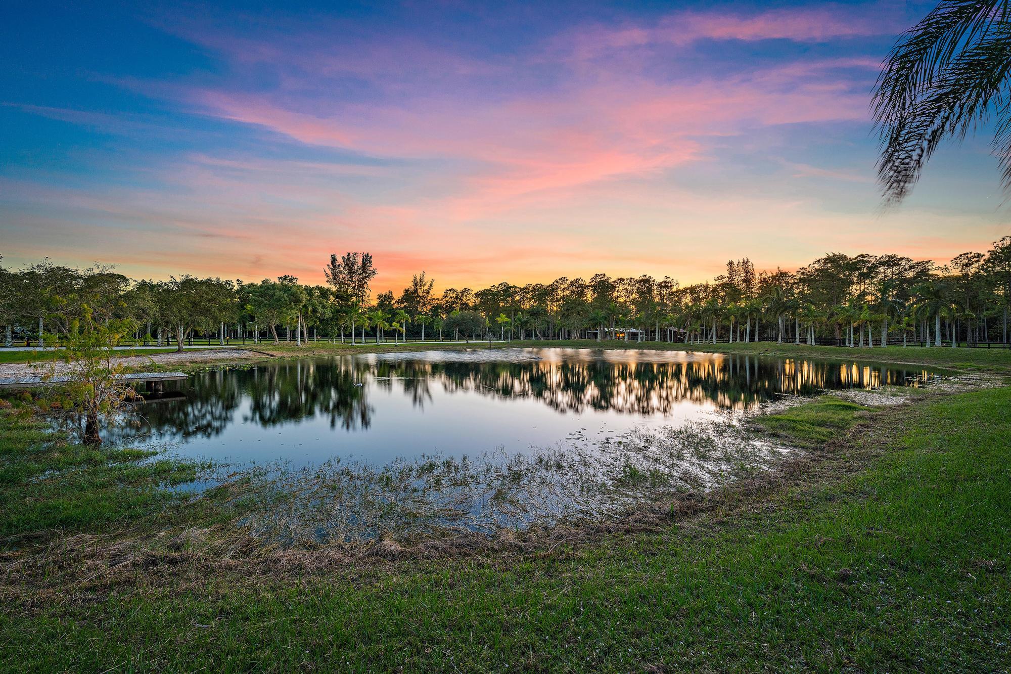 14765 Calusa Trail Palm Beach Gardens, FL 33418 - Photo 47 of 49 a view of a lake with a big yard