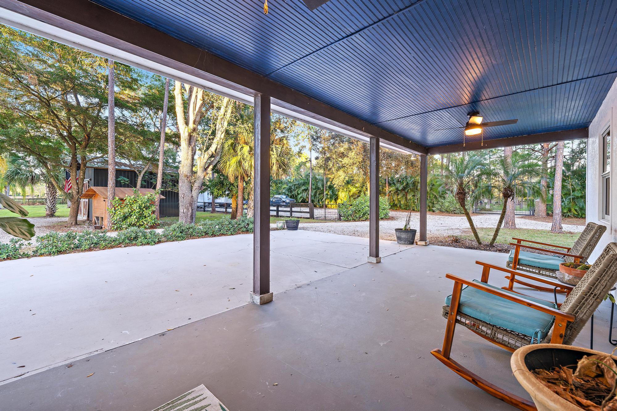 14765 Calusa Trail Palm Beach Gardens, FL 33418 - Photo 8 of 49 a building outdoor space with seating