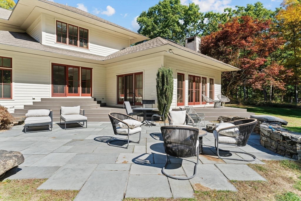 15 Partridge Lane Boxford, MA 01921 - Photo 34 of 42 a view of a patio with couches table and chairs with plants and garden