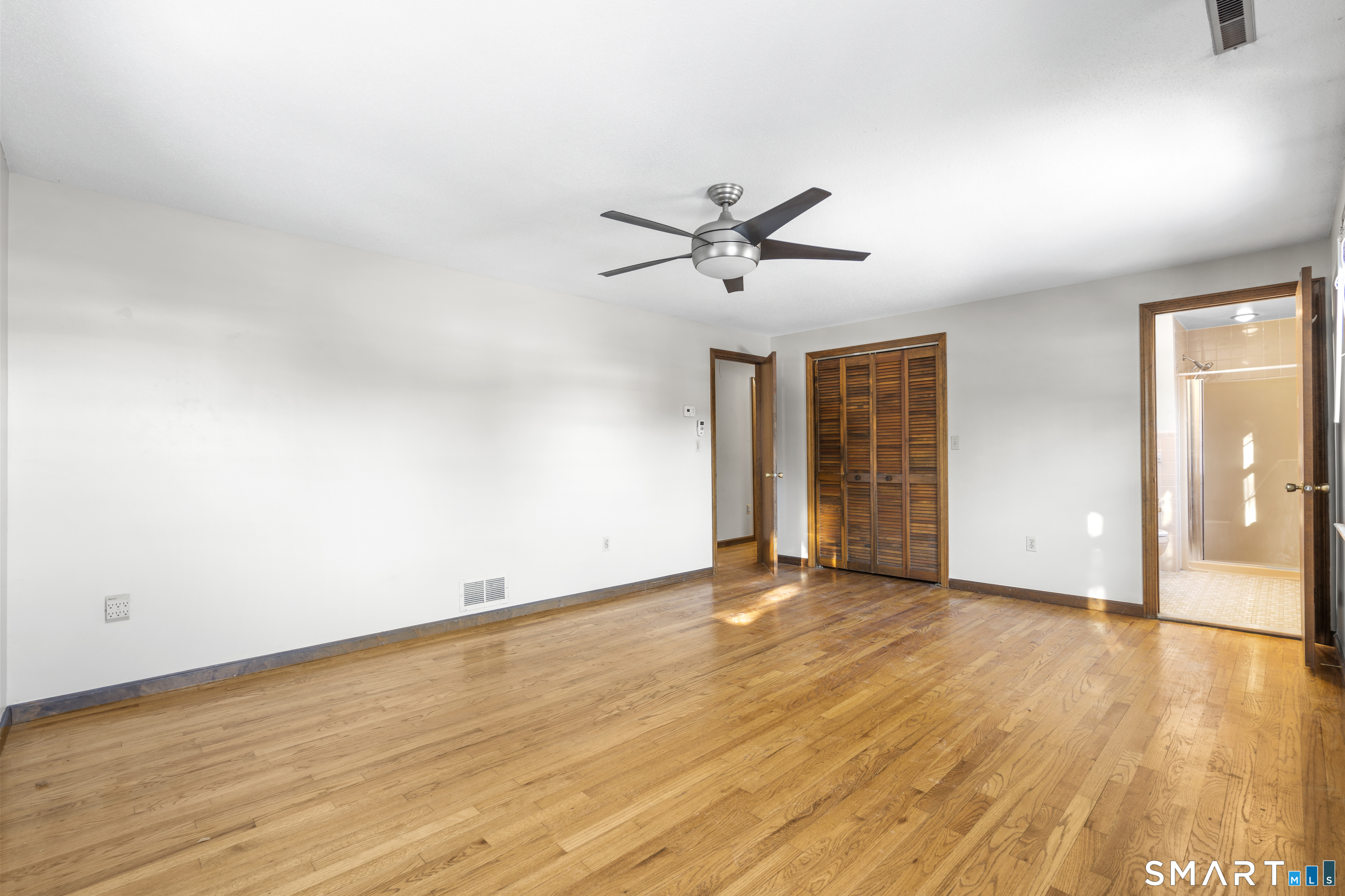 52 Laura Road Hamden, CT 06514 - Photo 16 of 35 an empty room with wooden floor and windows