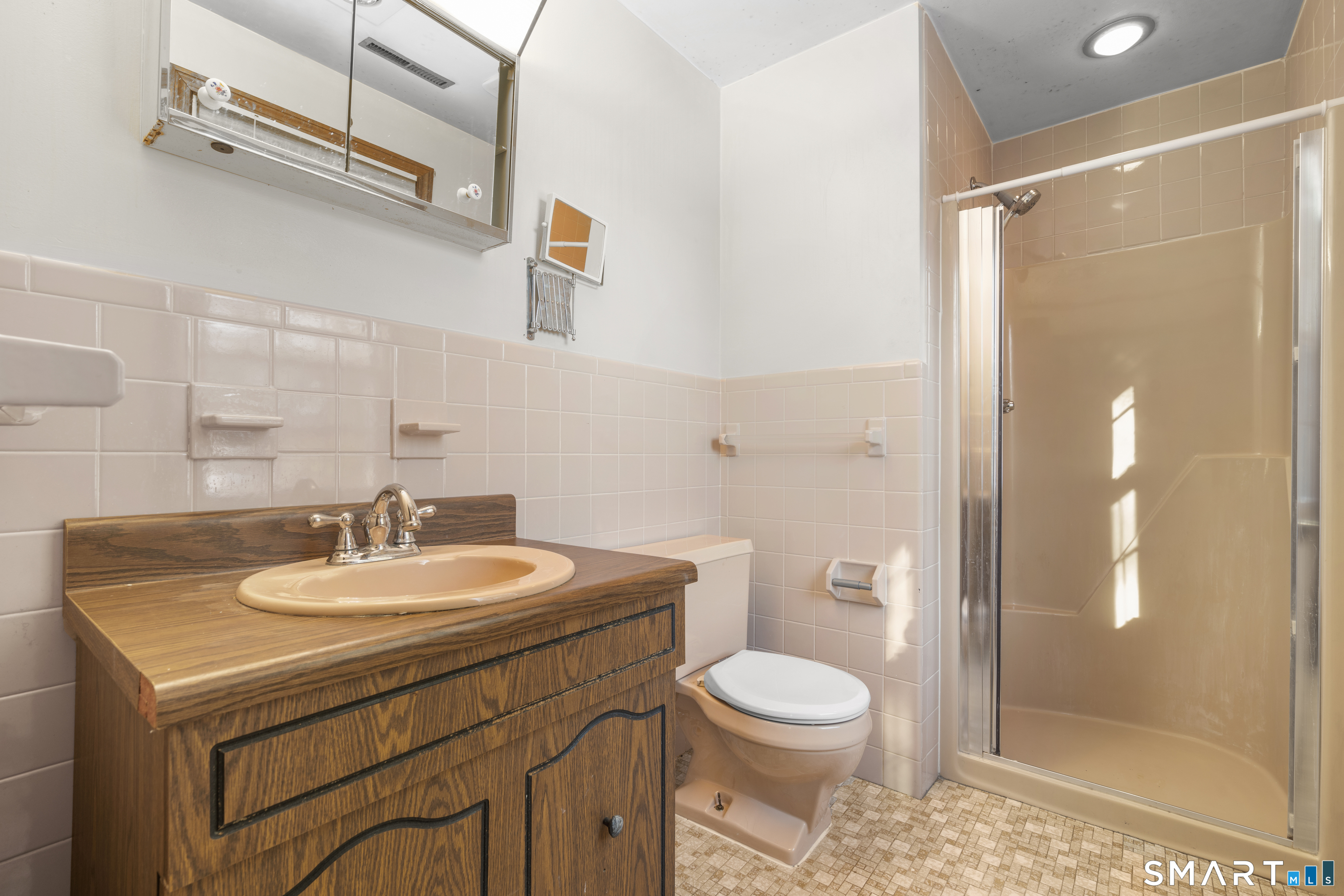 52 Laura Road Hamden, CT 06514 - Photo 17 of 35 a bathroom with a sink a toilet and shower