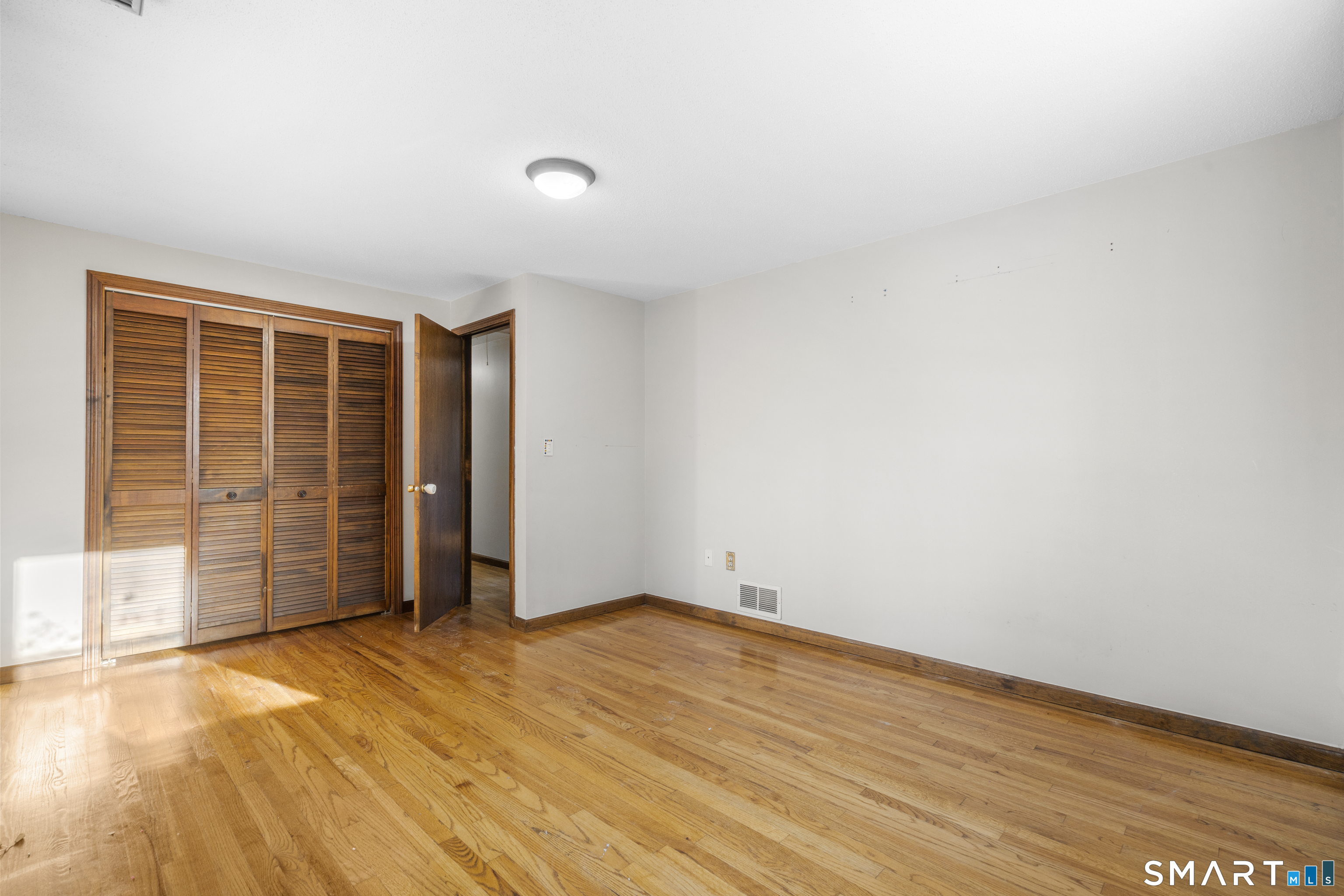52 Laura Road Hamden, CT 06514 - Photo 21 of 35 an empty room with wooden floor and white walls