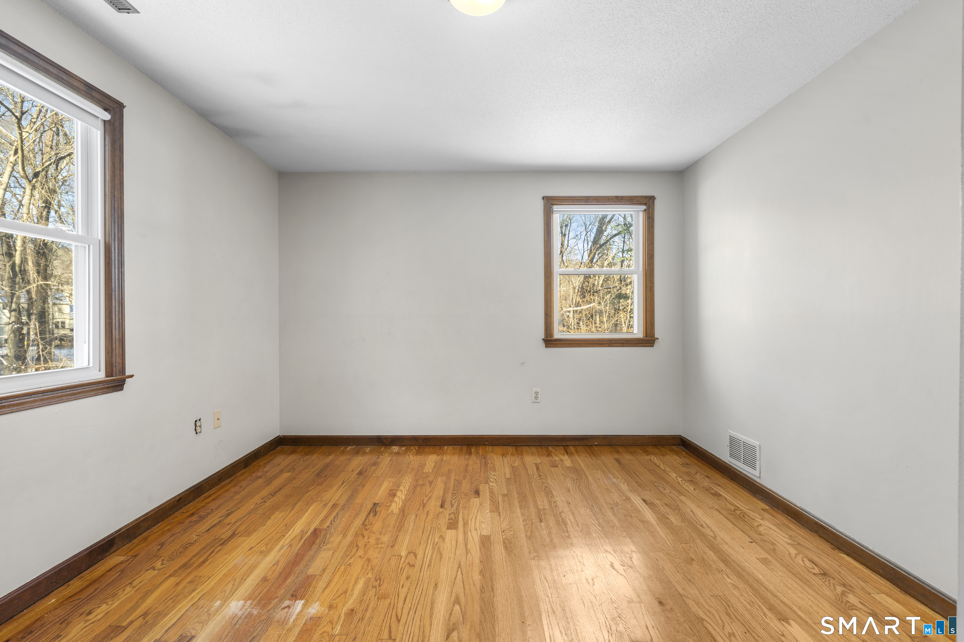 52 Laura Road Hamden, CT 06514 - Photo 24 of 35 an empty room with wooden floor and windows