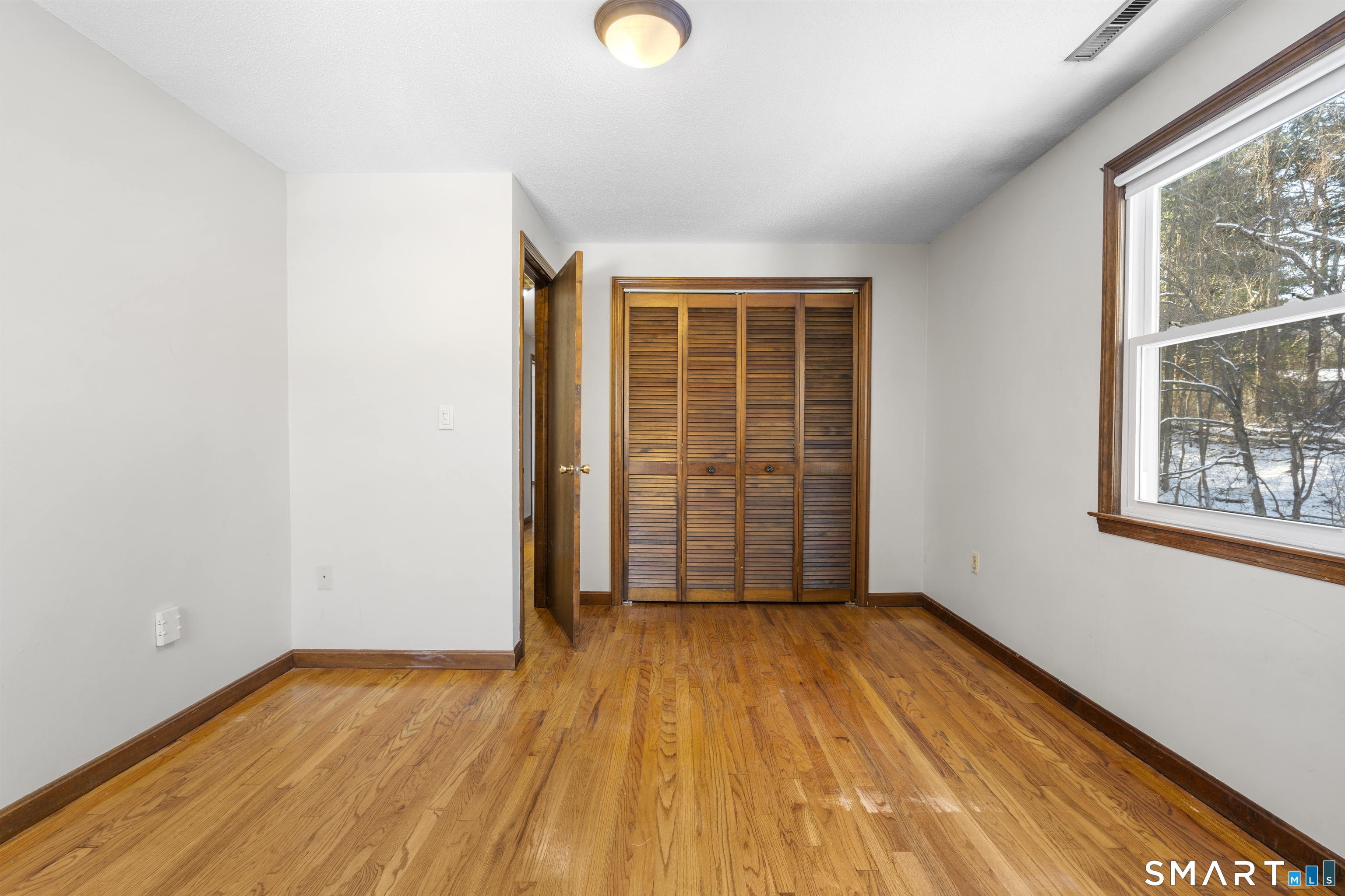 52 Laura Road Hamden, CT 06514 - Photo 25 of 35 an empty room with wooden floor and windows