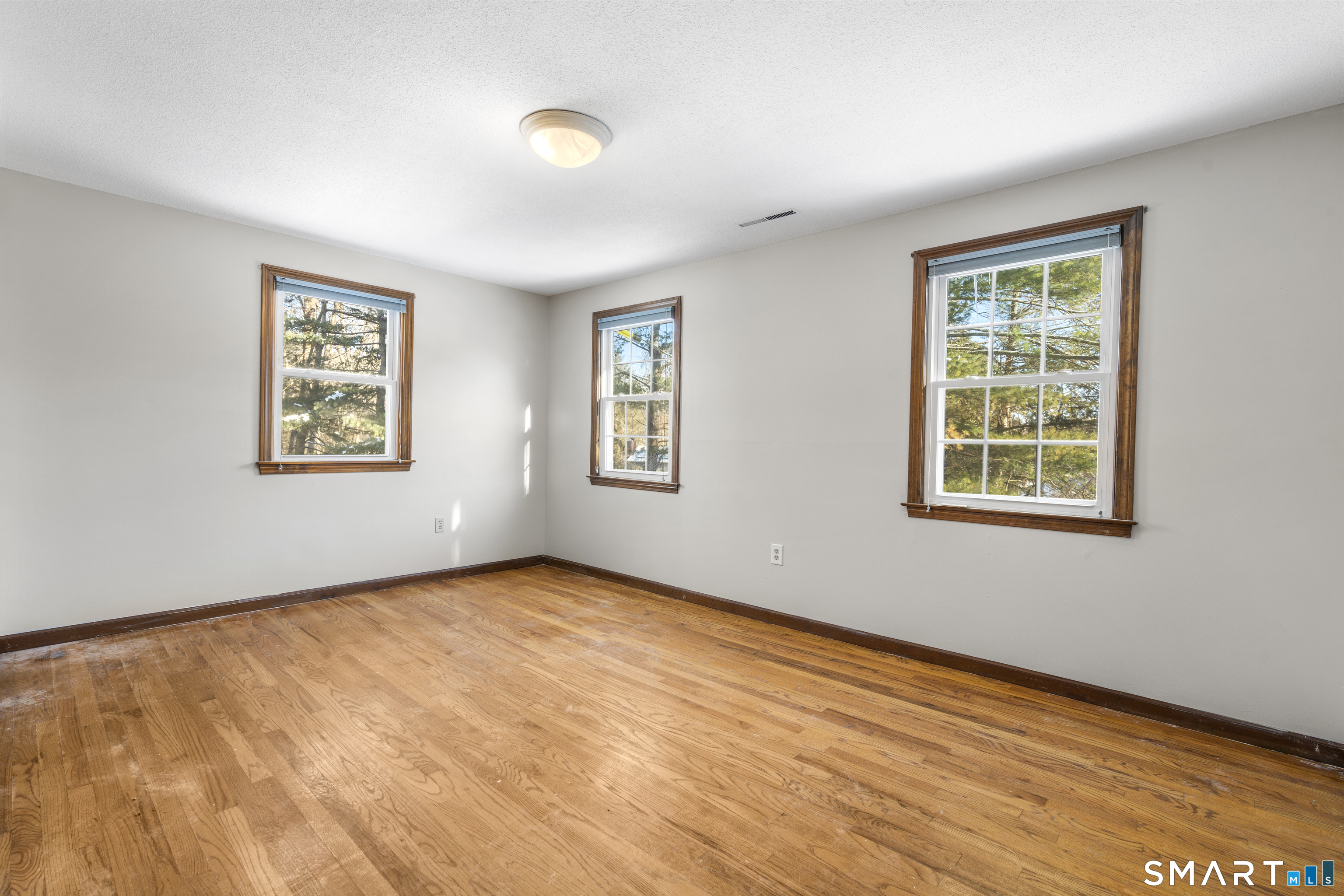 52 Laura Road Hamden, CT 06514 - Photo 27 of 35 a view of an empty room with window and wooden floor