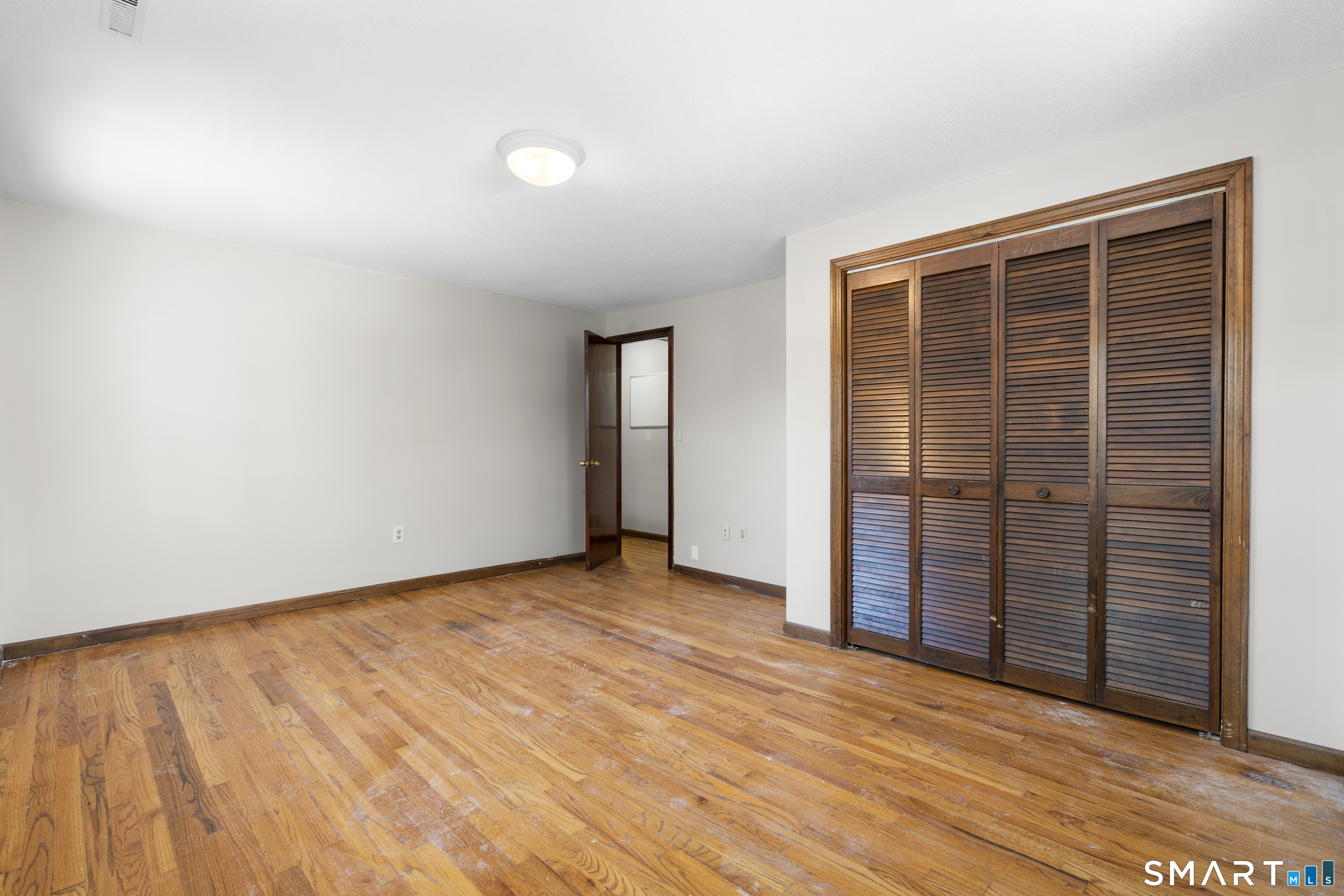 52 Laura Road Hamden, CT 06514 - Photo 29 of 35 an empty room with wooden floor and windows