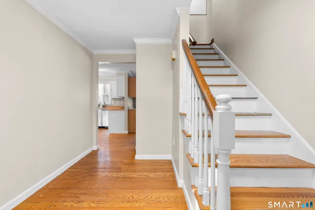 a view of an entryway with wooden floor
