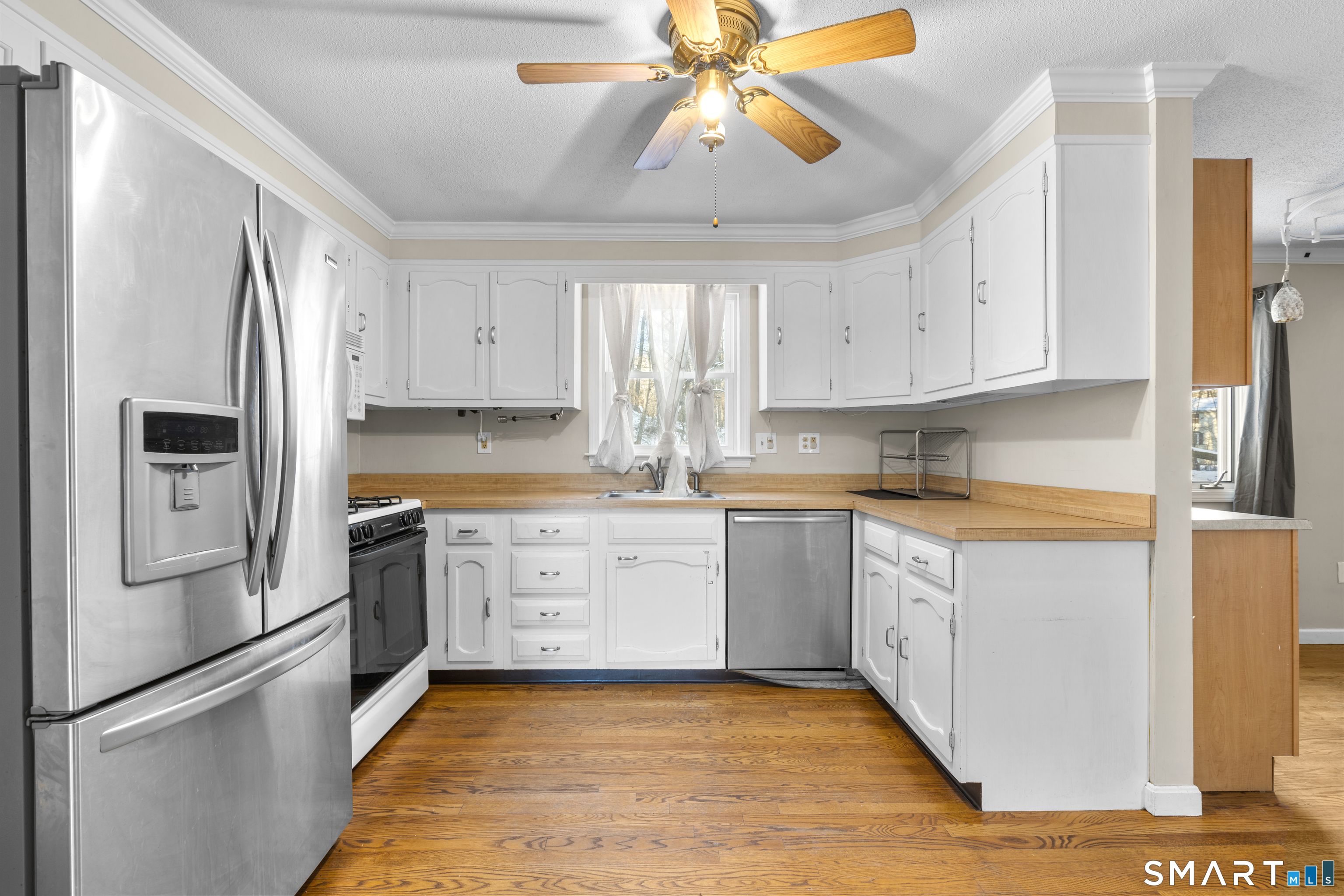 52 Laura Road Hamden, CT 06514 - Photo 4 of 35 a kitchen with granite countertop a refrigerator a sink a stove and white cabinets