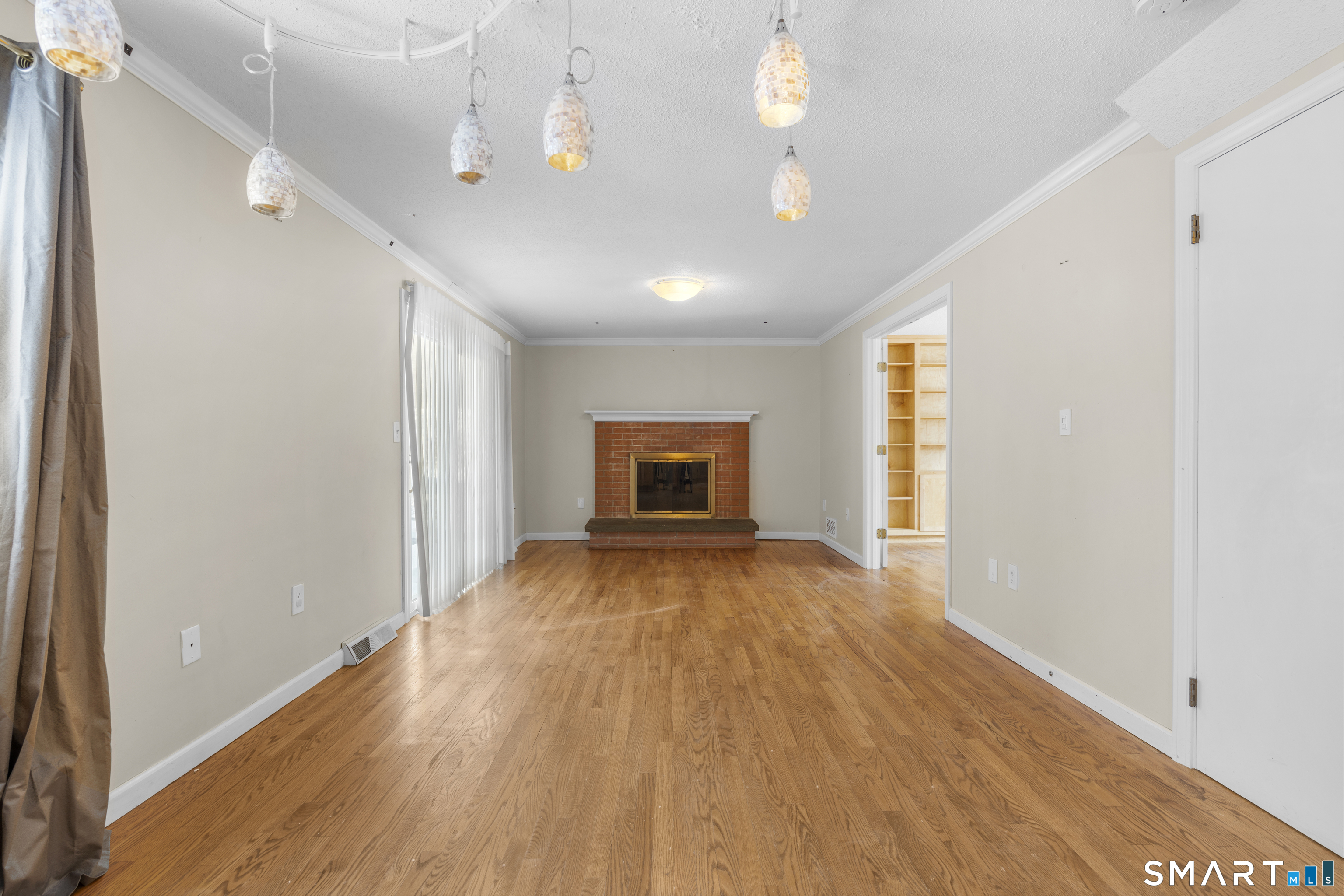 52 Laura Road Hamden, CT 06514 - Photo 8 of 35 a view of empty room with wooden floor and fan