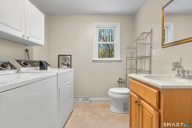 a bathroom with a sink toilet and a vanity