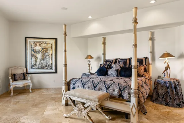 a bedroom with furniture and a flat screen tv