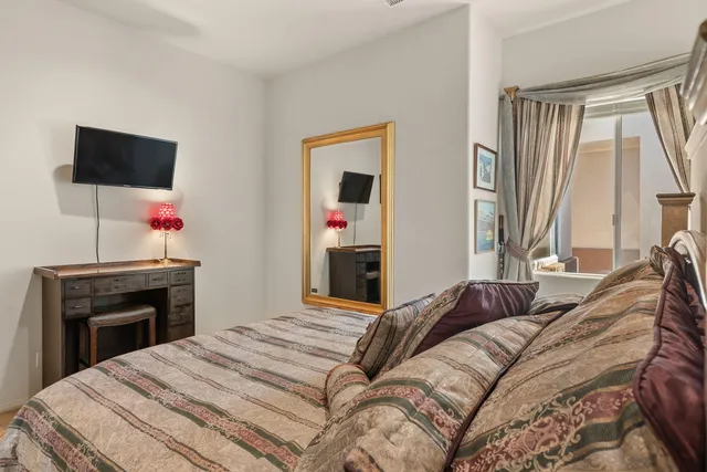 a bedroom with a bed and a flat screen tv