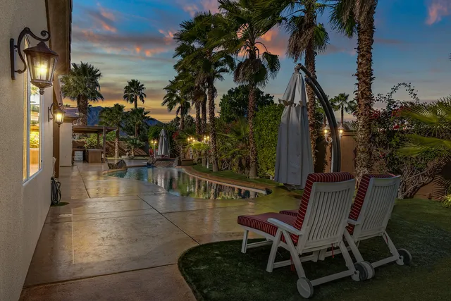 a view of an outside dining space with a table and chairs