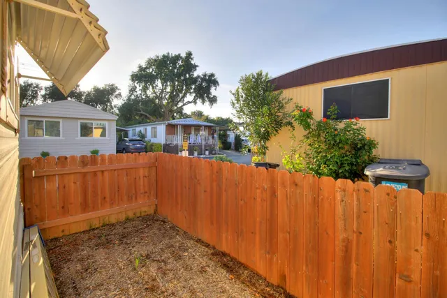 a view of a balcony with wooden floor and fence