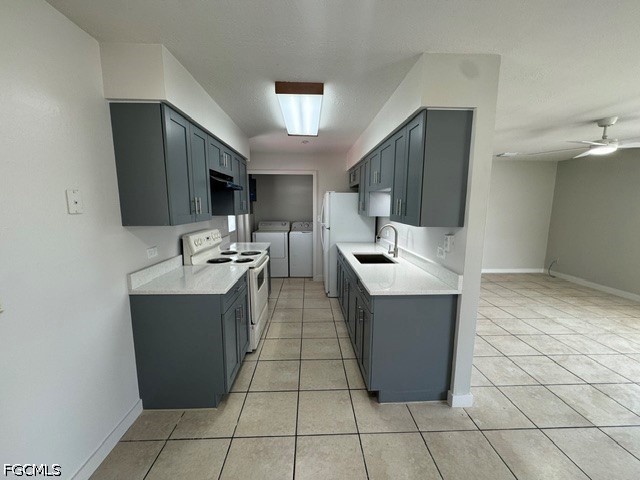26 Alabama Road South Lehigh Acres, FL 33936 - Photo 4 of 10 a kitchen with a sink a counter top space and cabinets