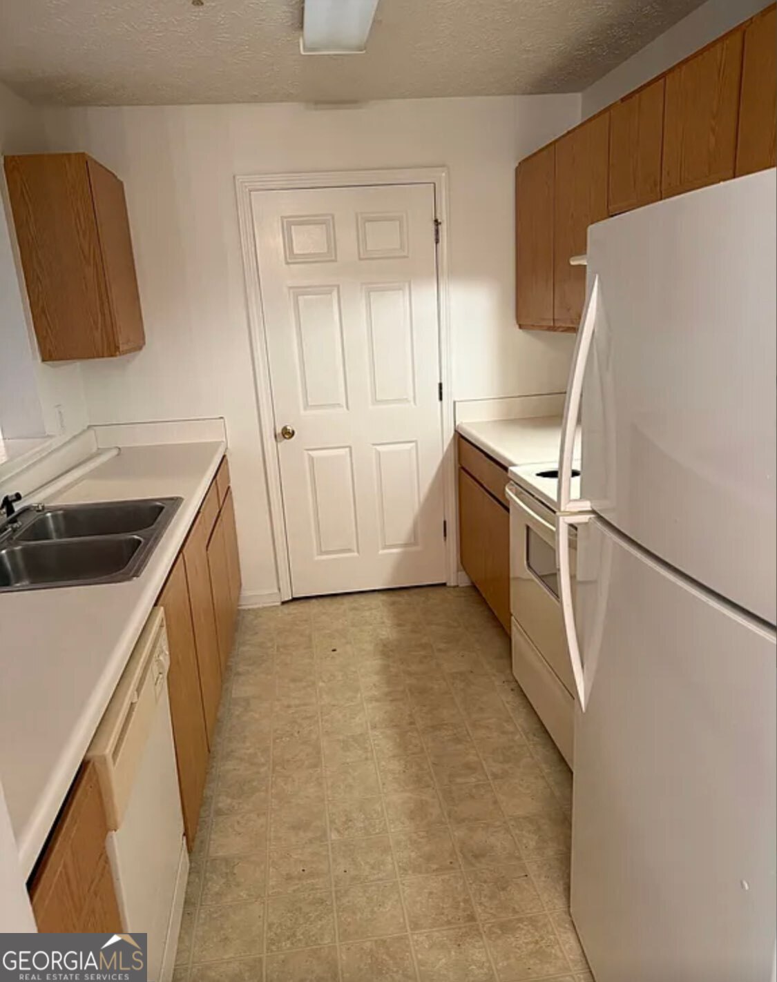 2204 Waldrop Place Decatur, GA 30034 - Photo 13 of 20 a kitchen with white cabinets and white appliances