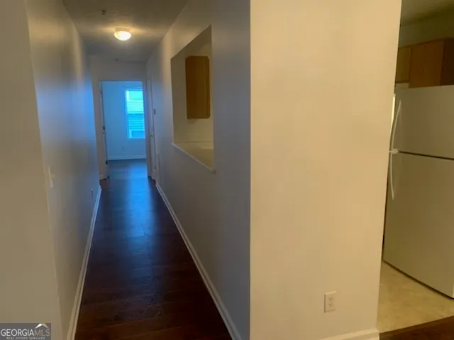 a view of a hallway with wooden floor