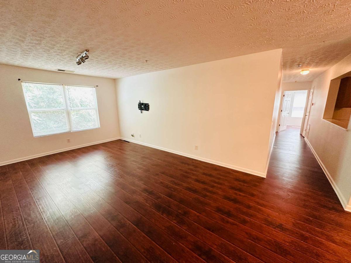 2204 Waldrop Place Decatur, GA 30034 - Photo 3 of 20 wooden floor in an empty room with a window