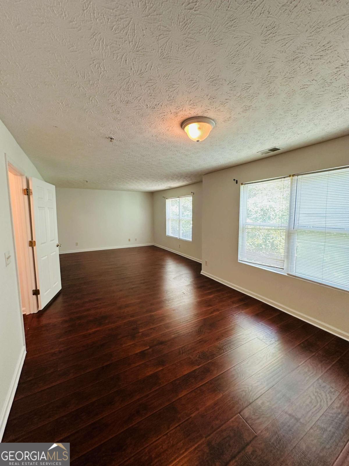 2204 Waldrop Place Decatur, GA 30034 - Photo 10 of 20 an empty room with wooden floor and windows
