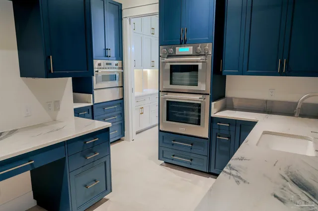a kitchen with cabinets and steel stainless steel appliances