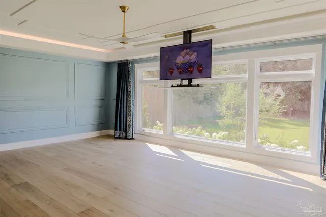 a view of an empty room with a fireplace and a window