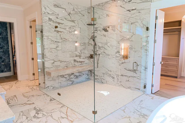 a white bath tub sitting next to a white sink