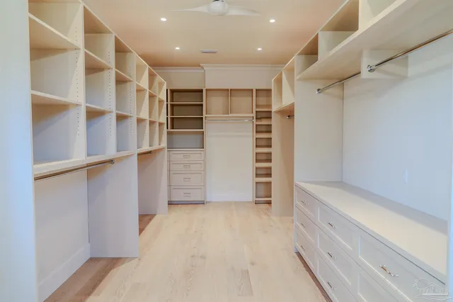 a view of walk in closet and window