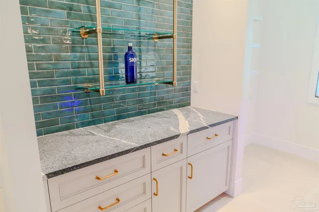 a utility room with granite countertop a sink and a stove