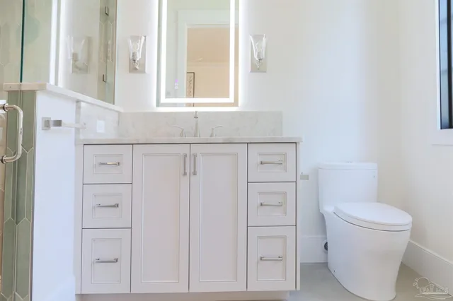 a bathroom with a glass shower door
