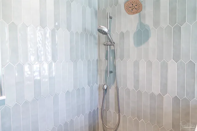 a bathroom with a granite countertop toilet and a sink