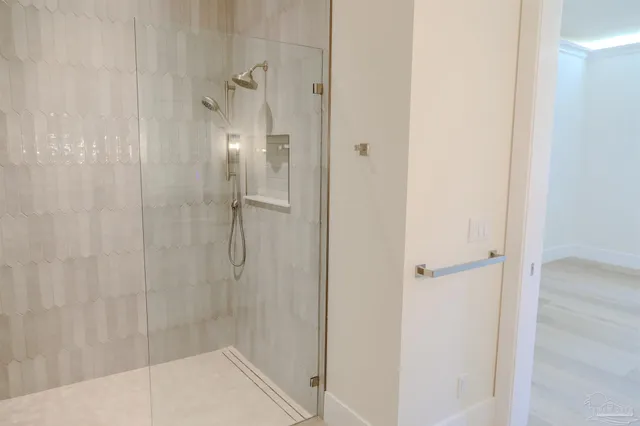 a view of staircase with white walls and a white door