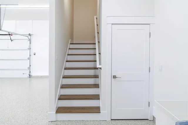 a view of an empty room with glass door and a window