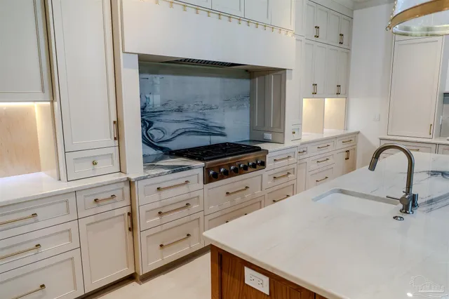 a kitchen with white cabinets and appliances