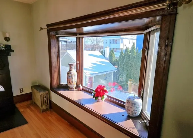 a kitchen with stainless steel appliances granite countertop wooden cabinets and window
