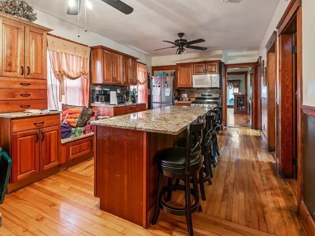 a kitchen with sink a stove and cabinets