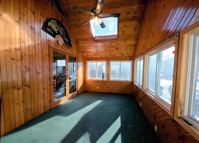 a bedroom with a bed and a flat tv screen on dresser