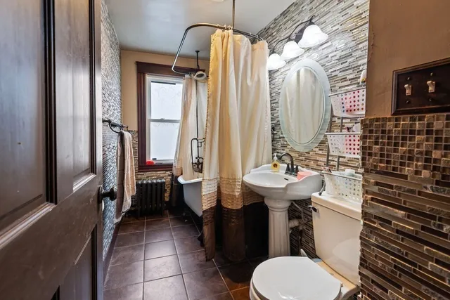 a kitchen with stainless steel appliances granite countertop a stove top oven a sink a dining table and chairs