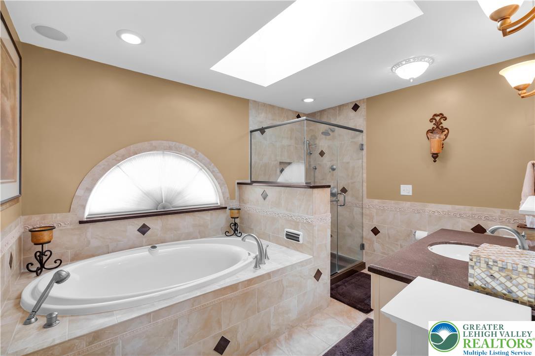 3830 McIntosh Drive Orefield, PA 18069 - Photo 17 of 36 a bathroom with a tub sink and mirror
