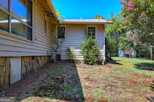 a backyard of a house with table and chairs
