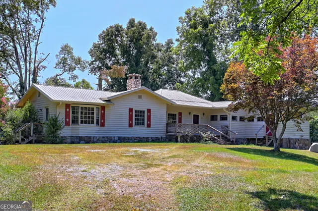 a view of house with a yard