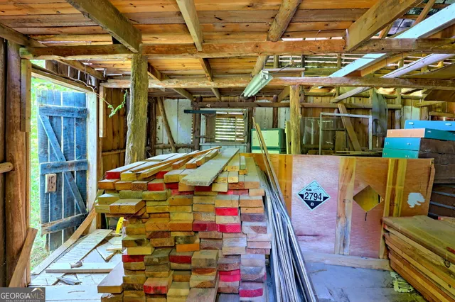 a view of house with a yard and sitting area