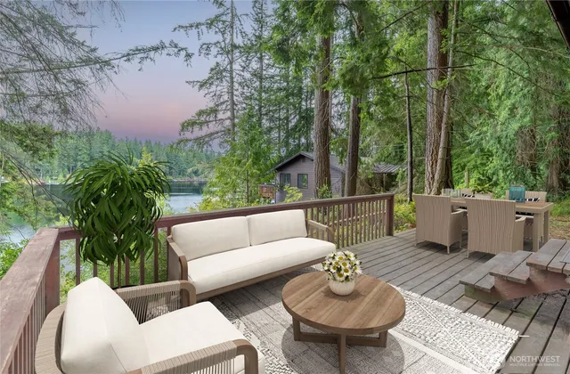 a balcony with couple of couches and potted plants